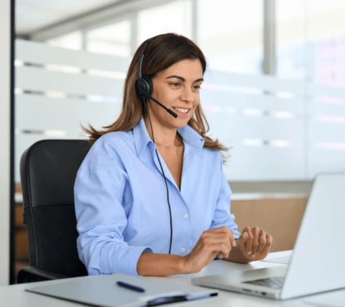 Customer Support representative wearing a headset talking to a customer