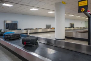 Suitcases on a baggage carousel in an airport baggage-claim hall