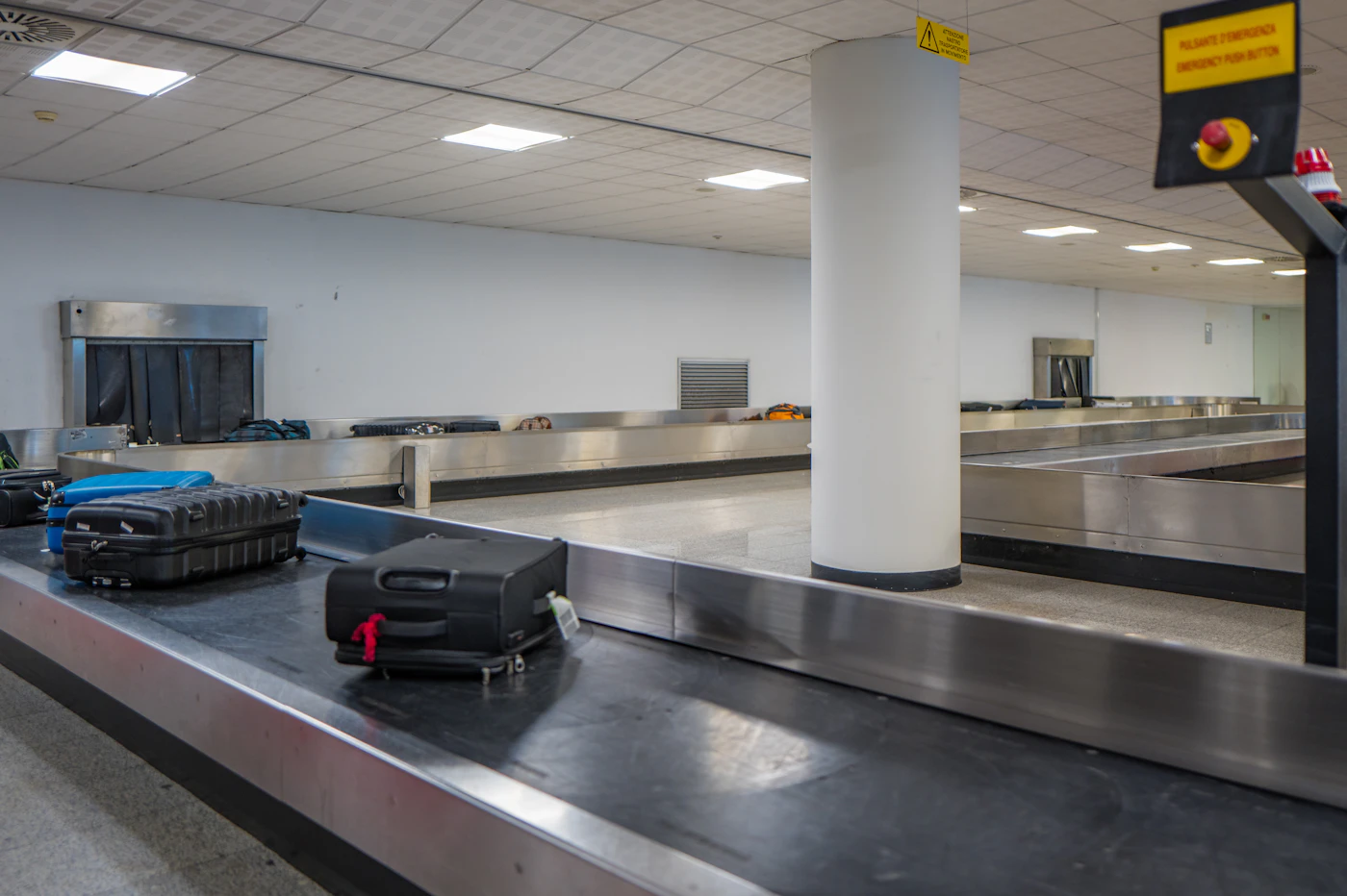 Suitcases on a baggage carousel in an airport baggage-claim hall