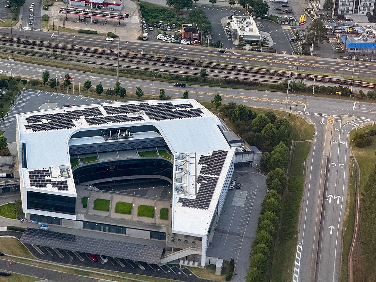Aerial view of the Porsche Experience Center Atlanta building and surrounding roads, photographed in June 2024
