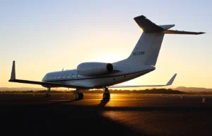 Private aircraft parked on an airport apron in golden evening light